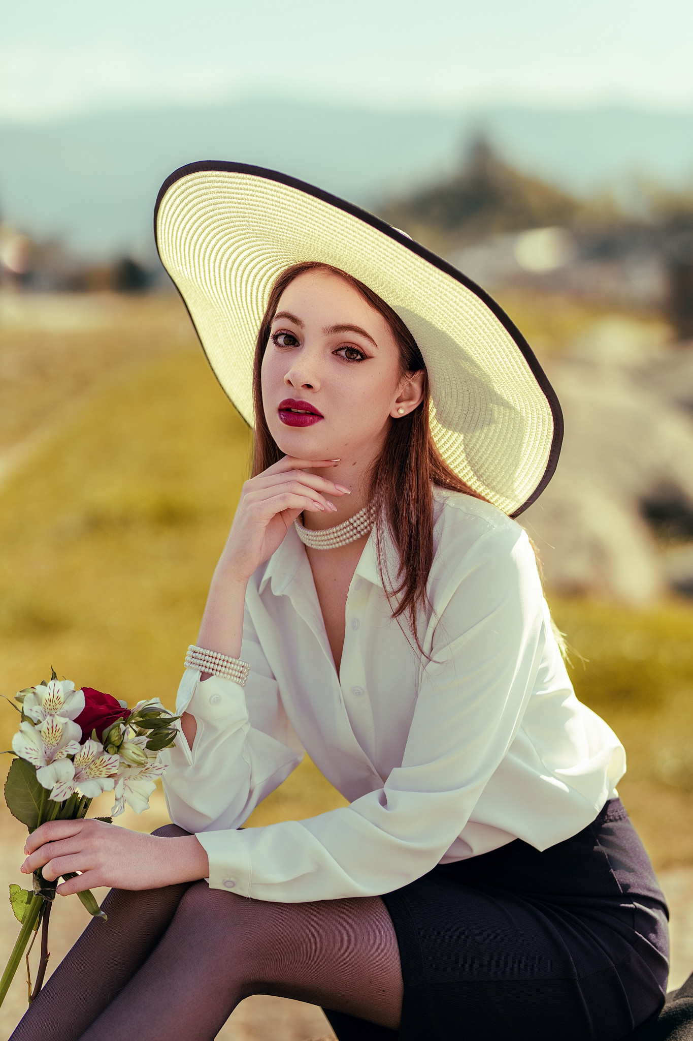 Outdoor brand campaign, wide-brim hat, white shirt, golden hour landscape