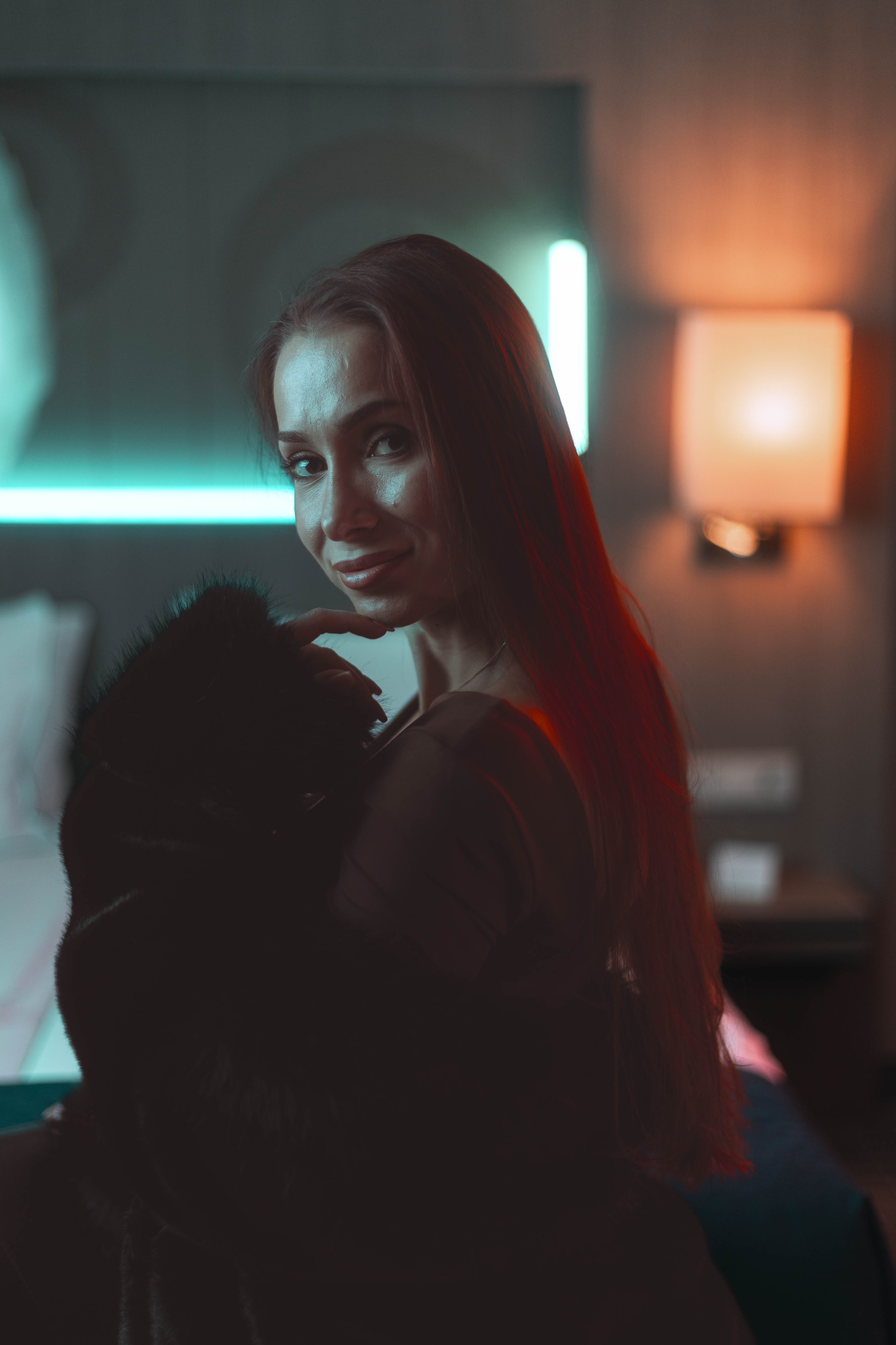 Editorial frontal portrait, dual amber and teal rim light, smile