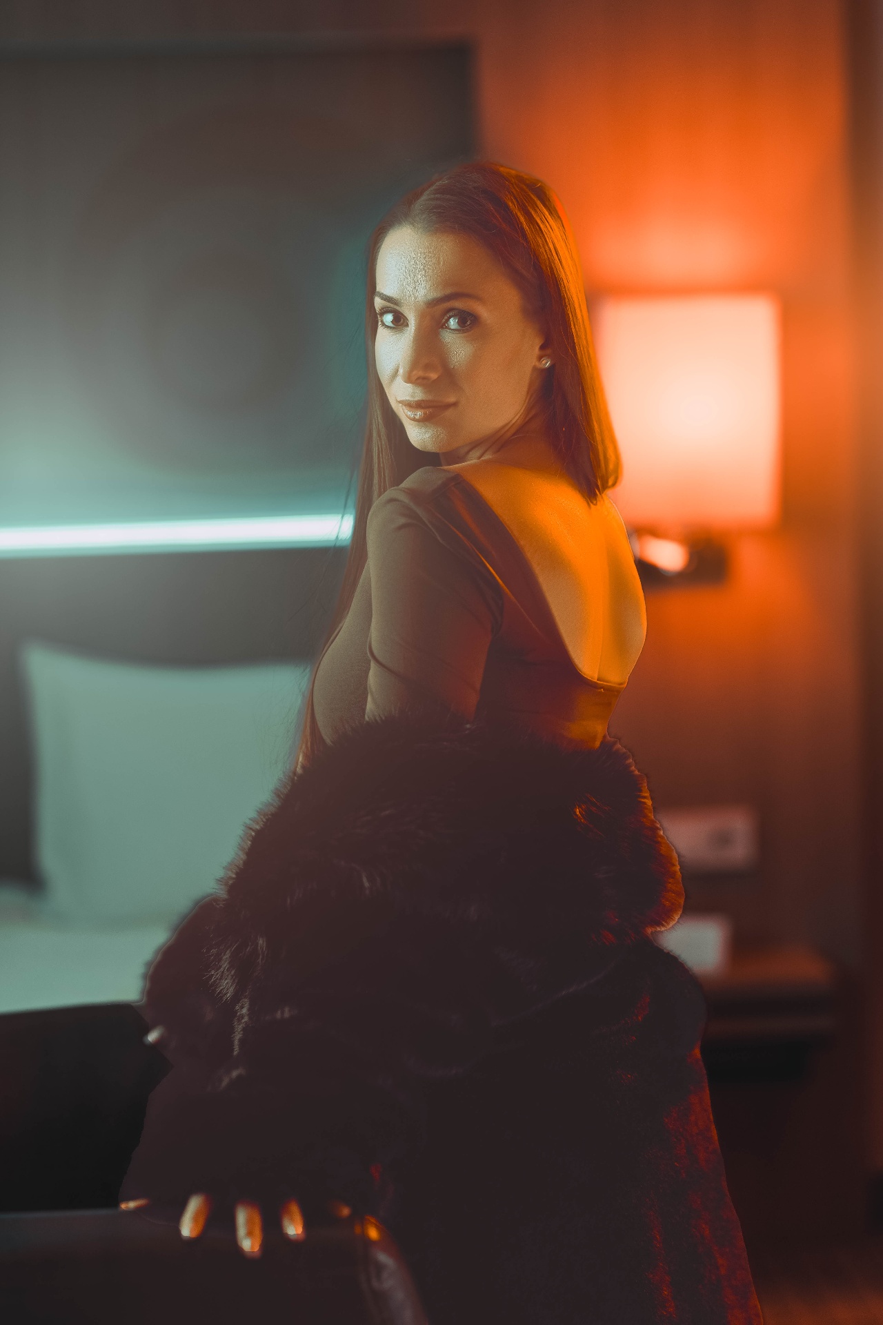 Editorial portrait, warm amber side light, low-key cinematic mood