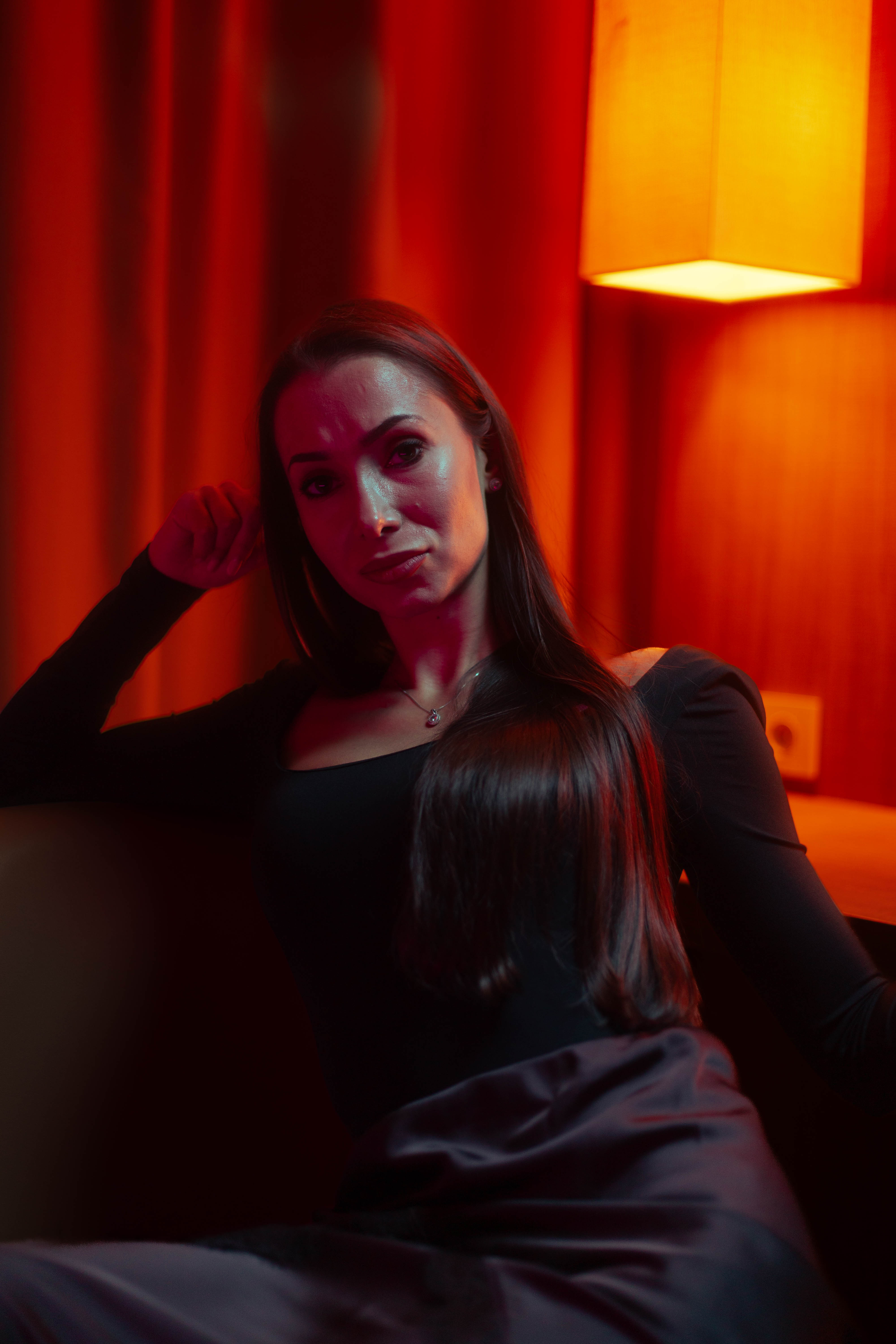 Luxury close portrait, teal-red colour split, painterly hotel suite