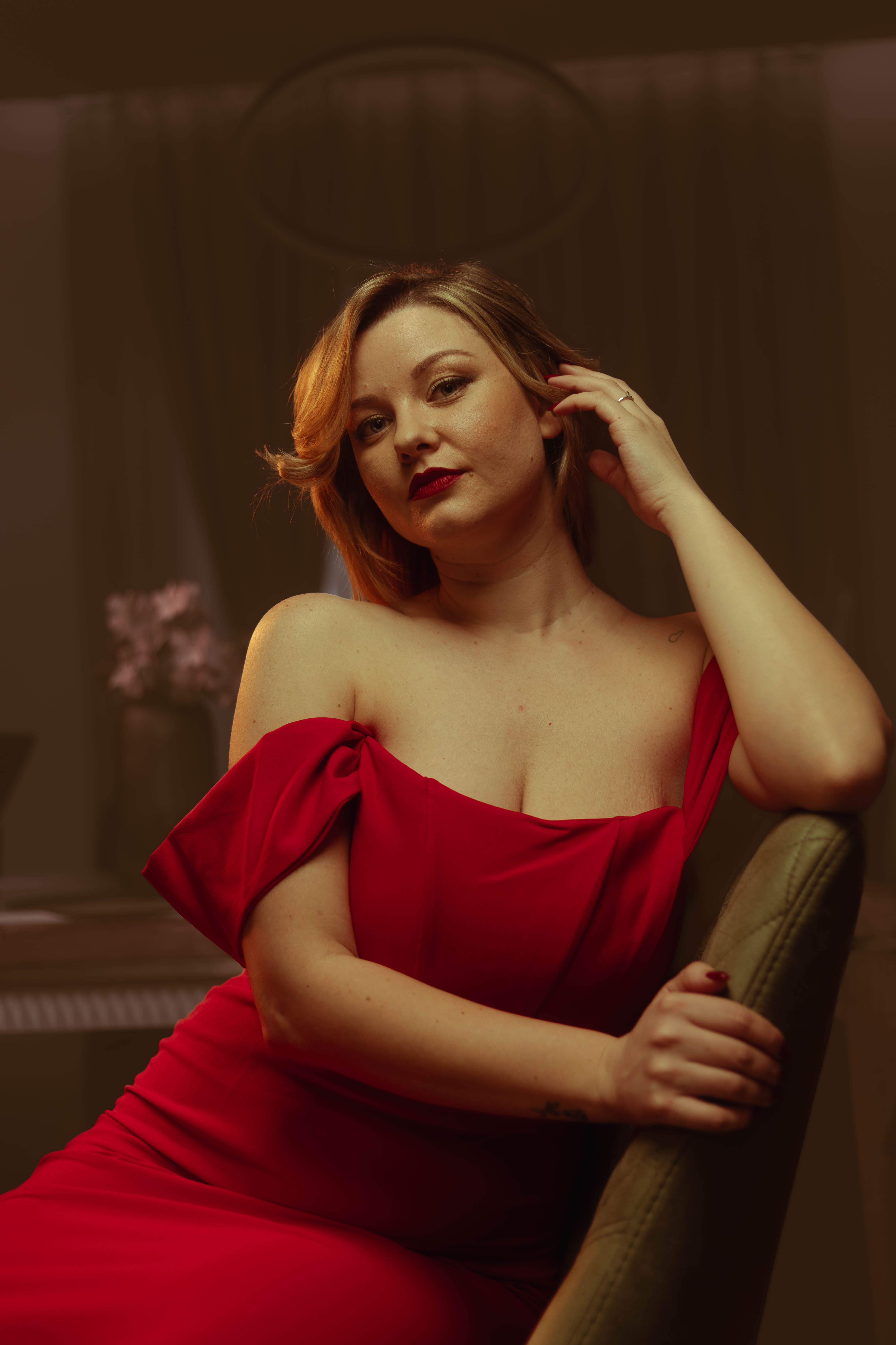 Fashion still, red dress, hand-in-hair gesture, warm vintage grade