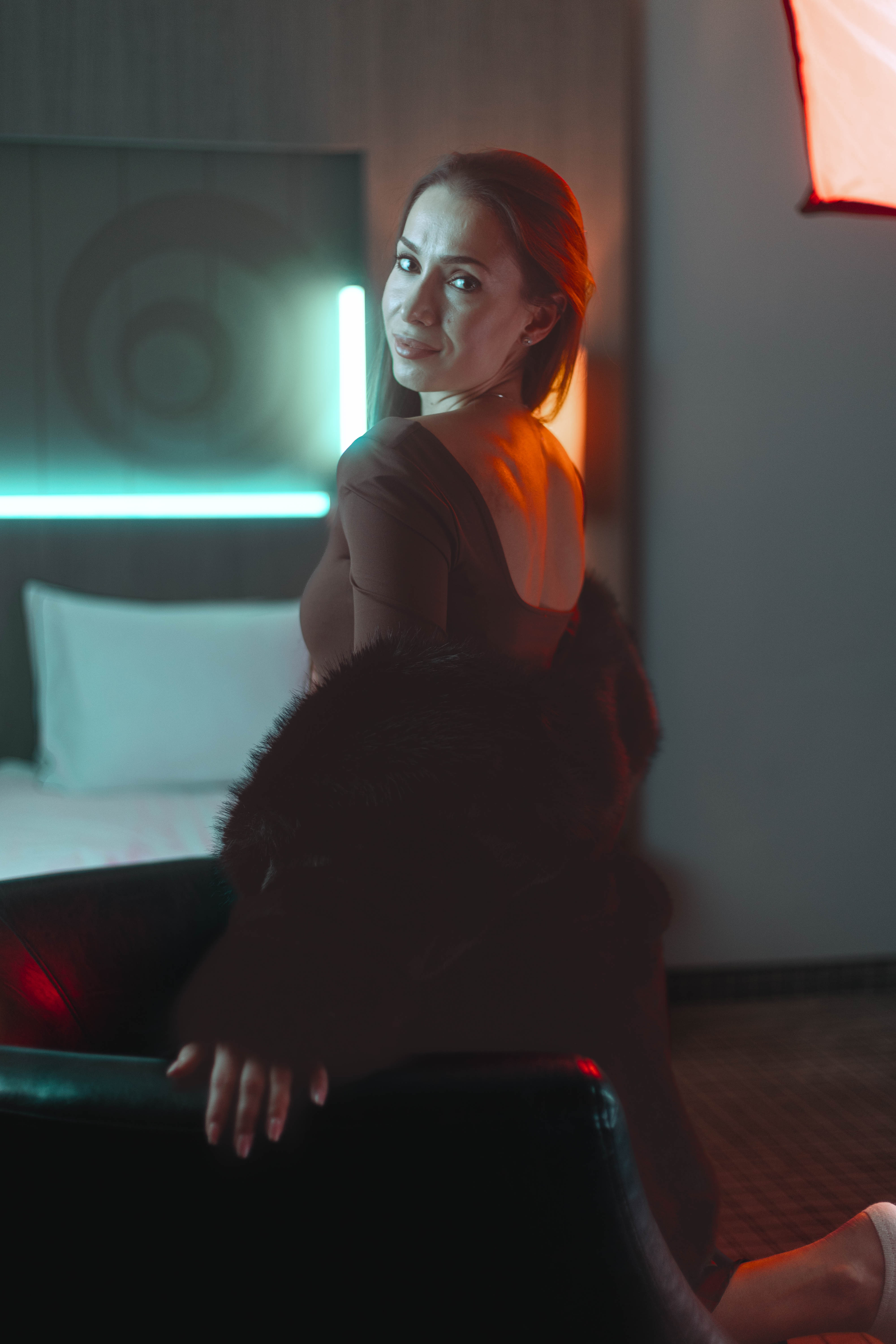 Editorial fur turn, sculpted teal back light and amber lamp glow