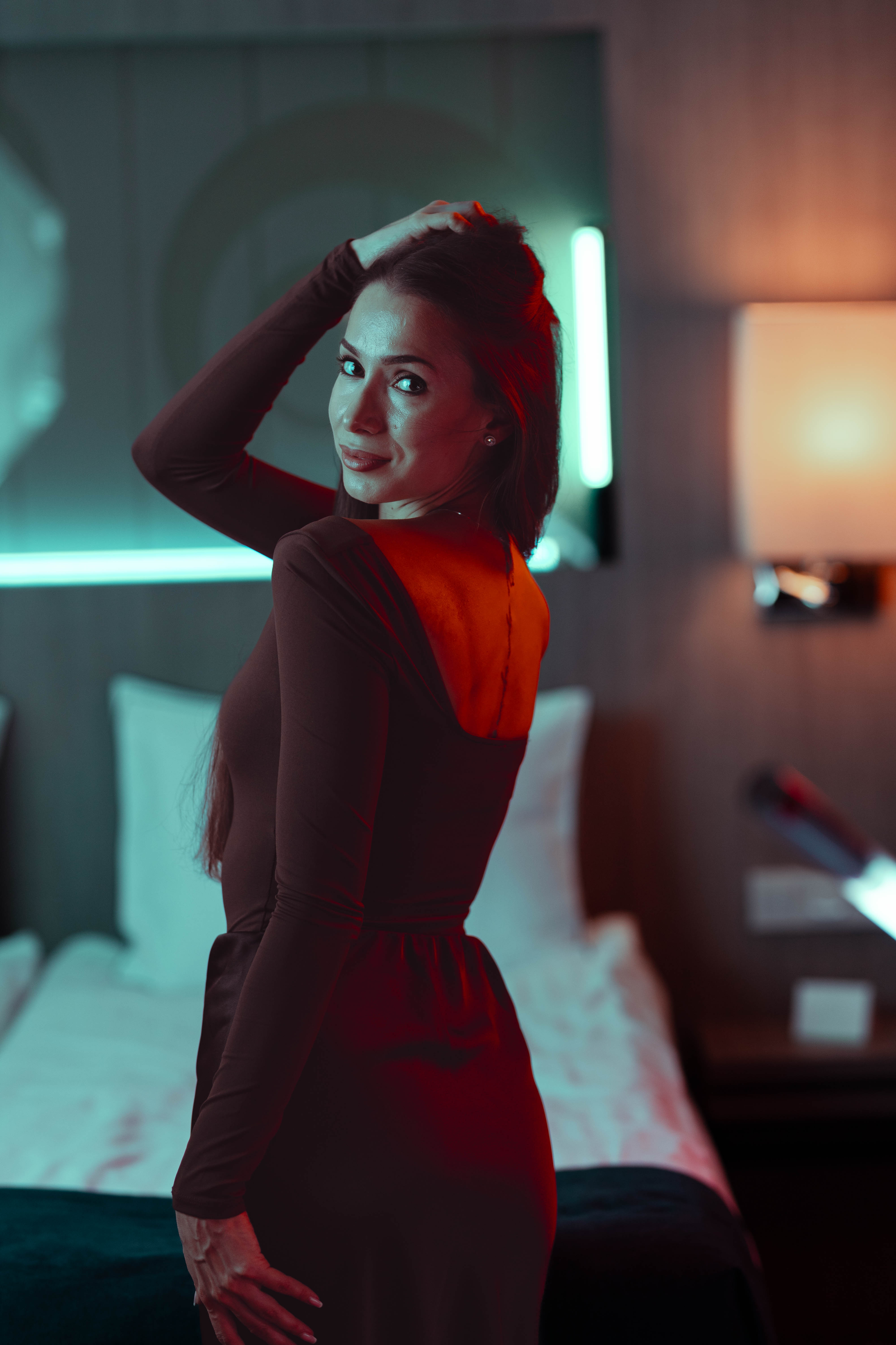 Brand campaign portrait, raised arm pose, ember and teal contrast