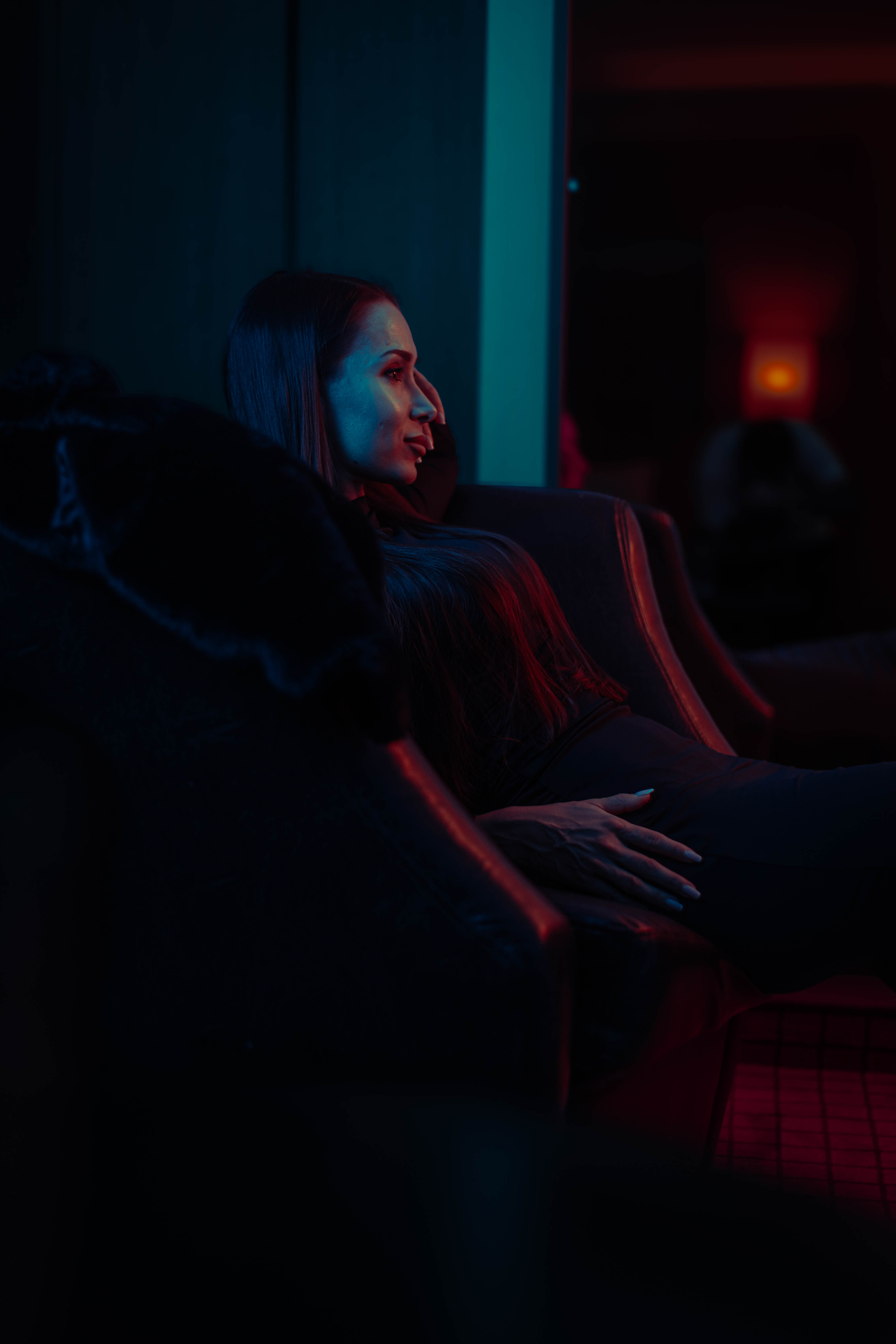 Fashion film, teal-crimson duotone, hotel lounge reclining frame