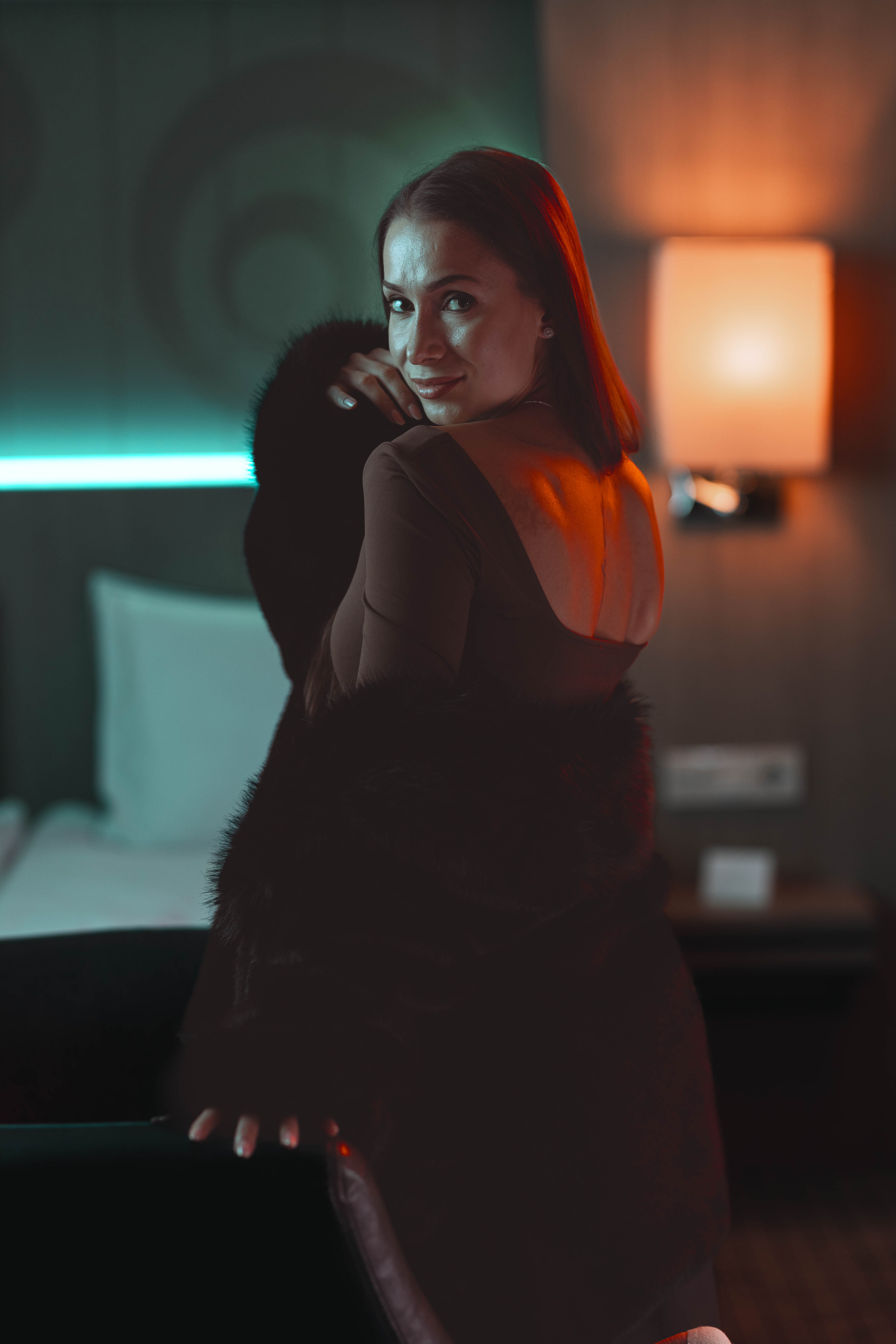 Fashion film still, fur coat, upward gaze, painterly suite light